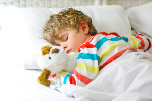 Child boy sleeping on his stomach on a pillow and pillowcase by A Little Pillow Company 100% USA Made from all USA organic and sustainable materials 