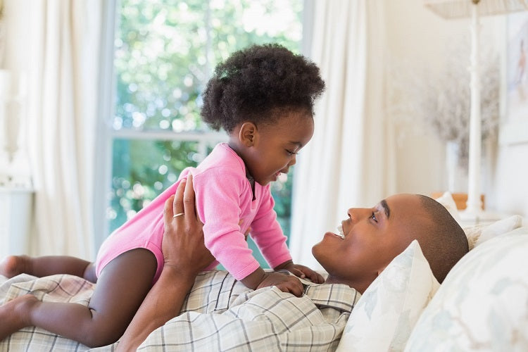 Man and baby on standard pillow from A Little Pillow Company