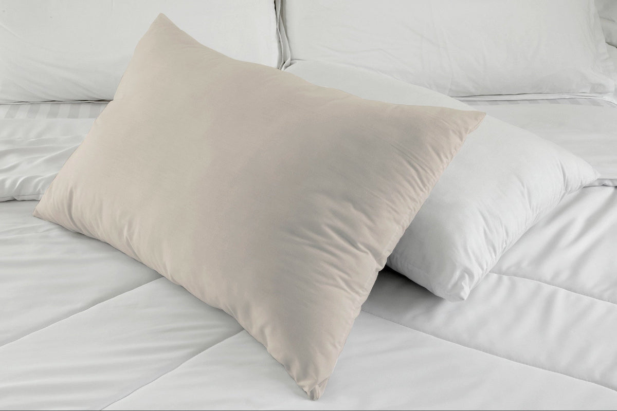 Two standard size organic pillowcases in white and natural on a bed by A Little Pillow Company. 100% Made in the USA.
