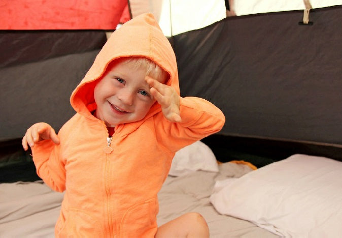 Boy using child pillow camping in a tent