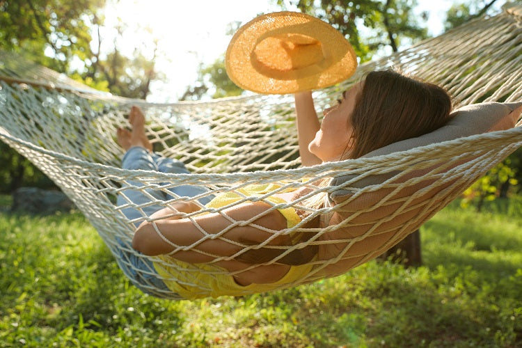 Woman in hammock using child pillow from A Little Pillow Company